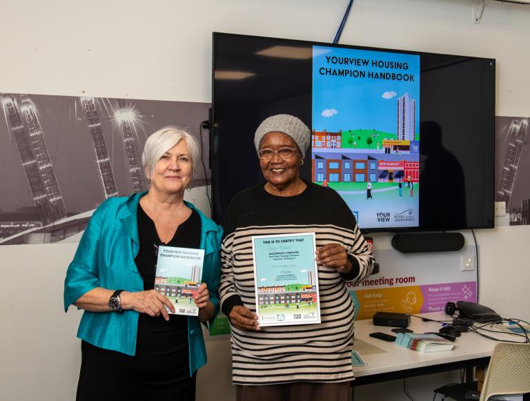 Two ladies holding Yourview Champion Housing Handbook